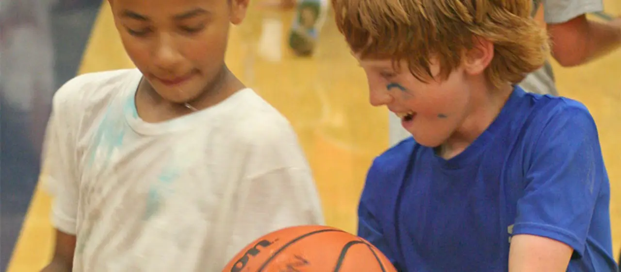 Kids working on passing drill at summer basketball camp.