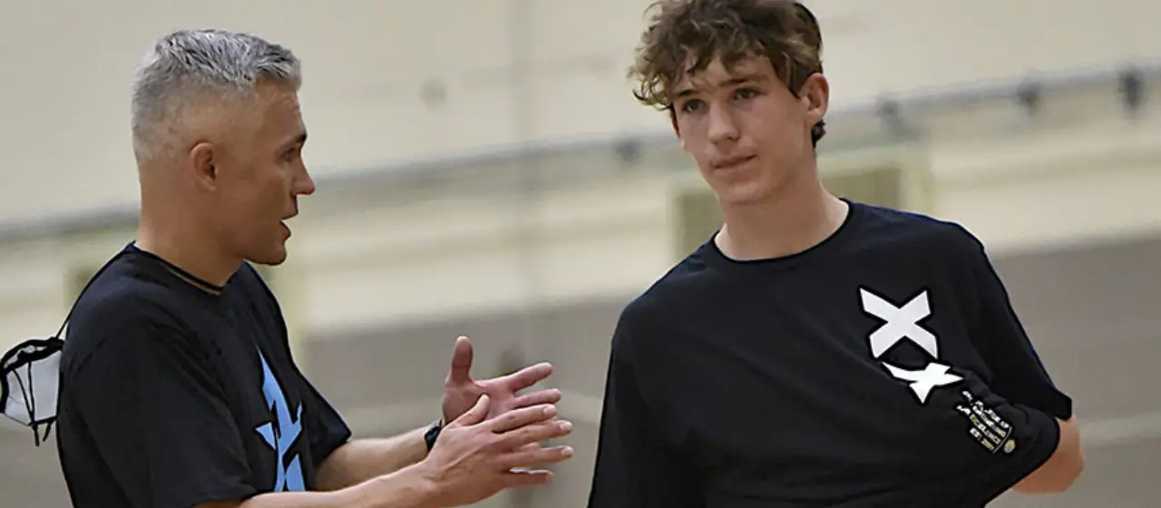 Coach gives feedback to college basketball prep athlete after scrimmage