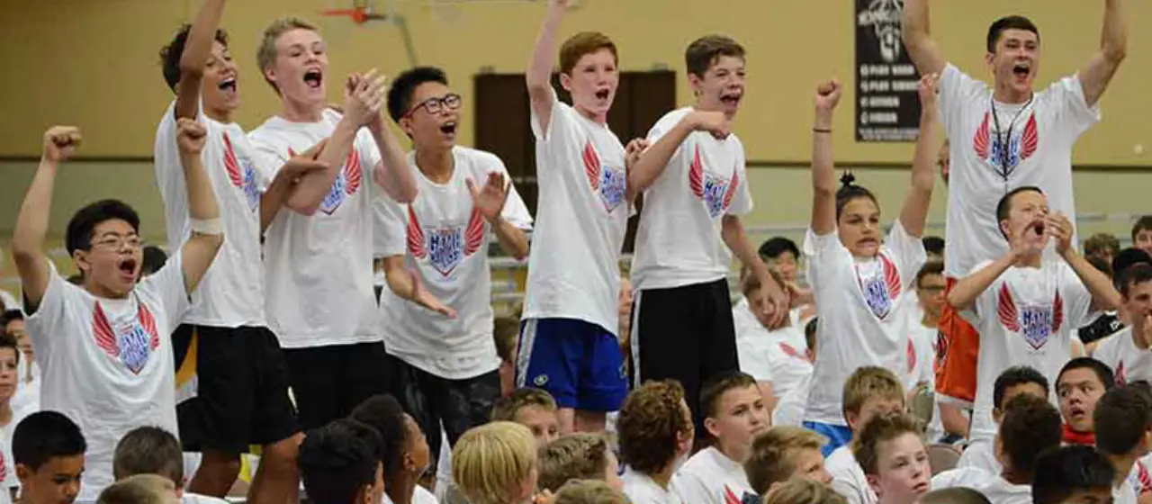 Campers cheer team representative at camp contest
