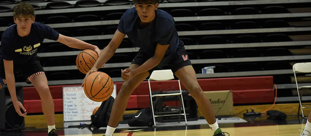 Basketball campers work on ball handling moves early morning camp workouts.