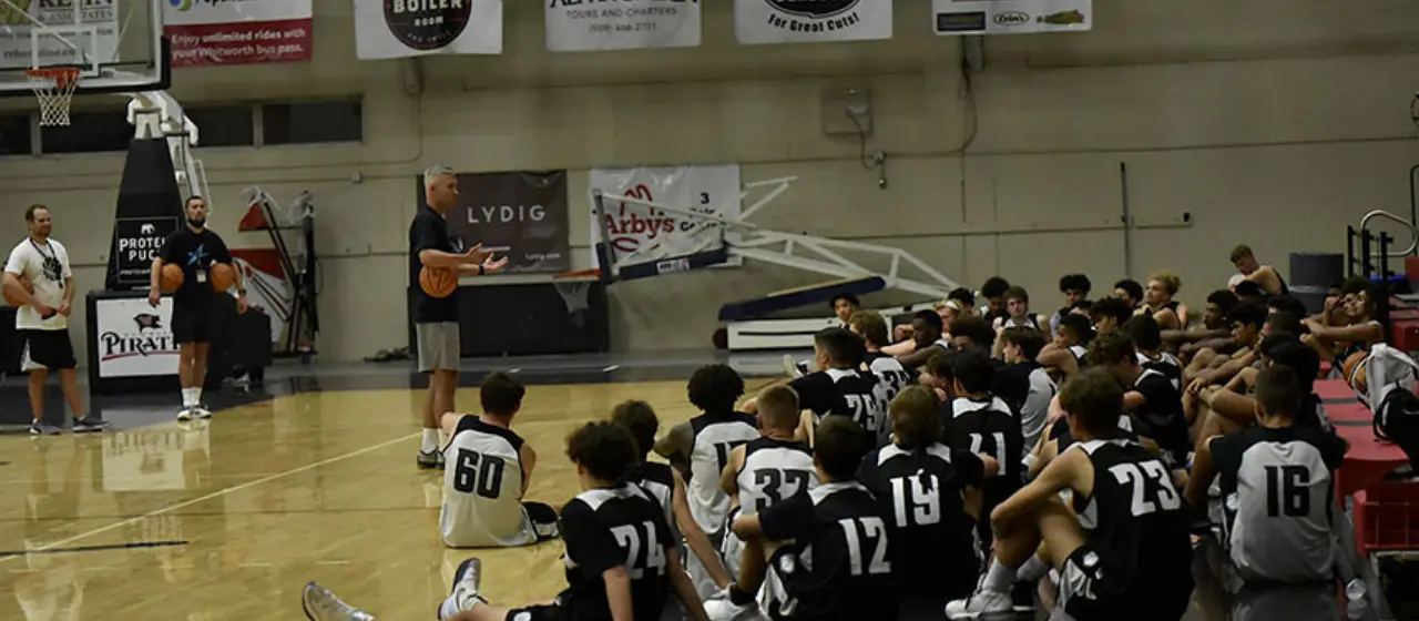 College prep players listen to coaches before tournament play