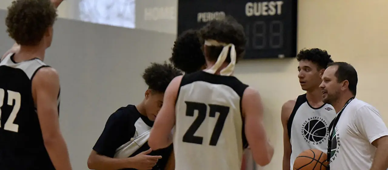Coach inspires players during timeout at NBC College Prep Camp