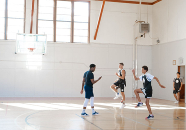 Coach training athletes for basketball camp workout