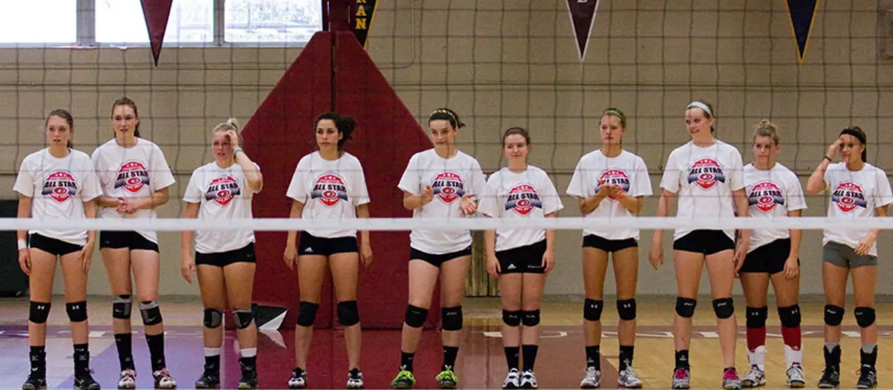 All-star volleyball players line up at the net at NBC Volleyball Camp.
