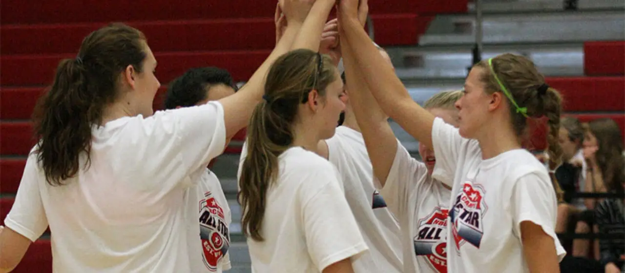 Student Athletes huddle up after volleyball all-star game at NBC Volleyball camps.