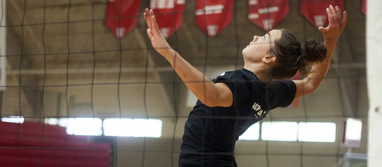 Athlete attempts a spike during volleyball camp