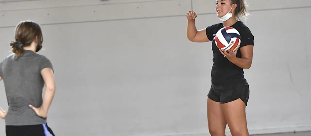 Coach gives volleyball instruction
