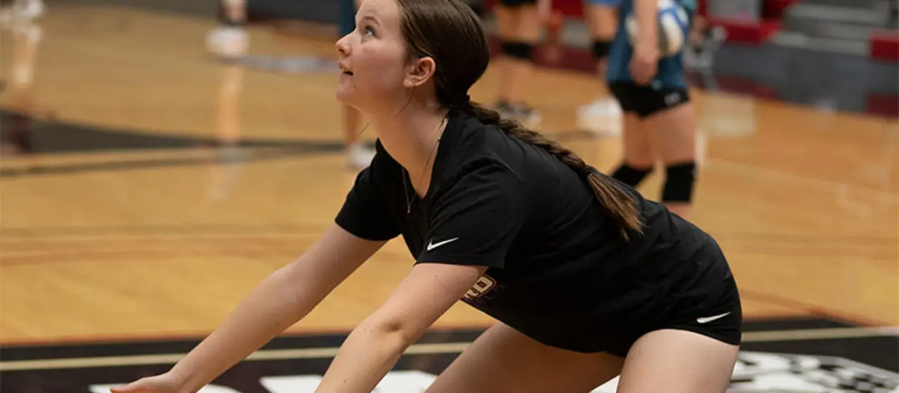 Volleyball player focuses intently on pass