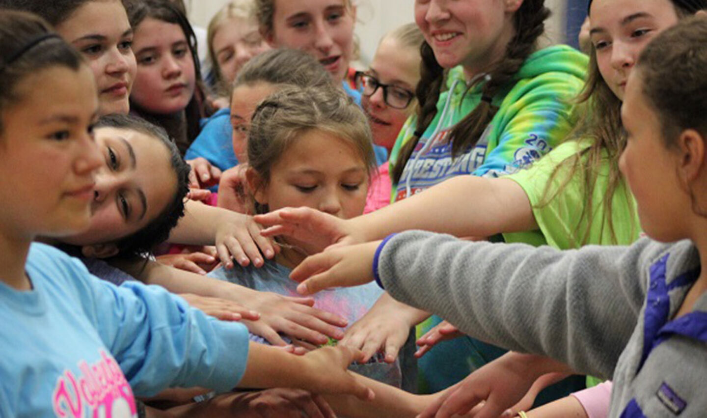 Campers huddle after NBC volleyball intensity night