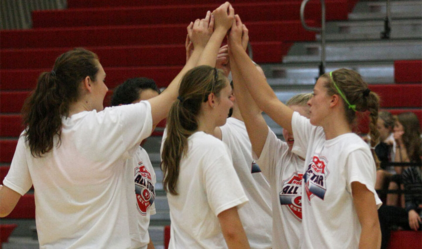 Student Athletes huddle up after volleyball all-star game at NBC Volleyball camps.
