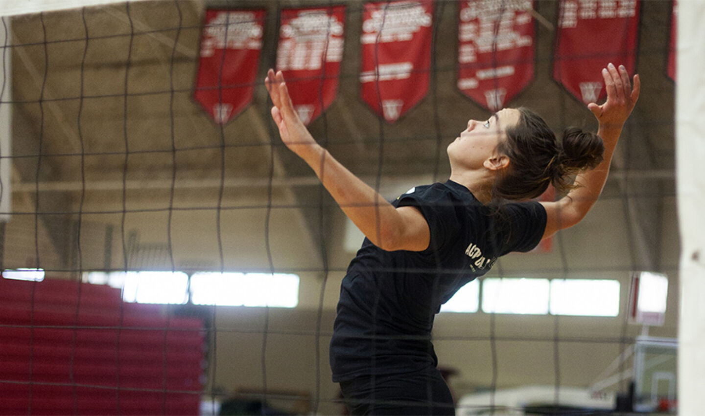 Athlete attempts a spike during volleyball camp