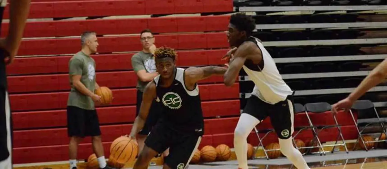 Athletes at college basketball prep camp at NBC Basketball drive to the basketball.