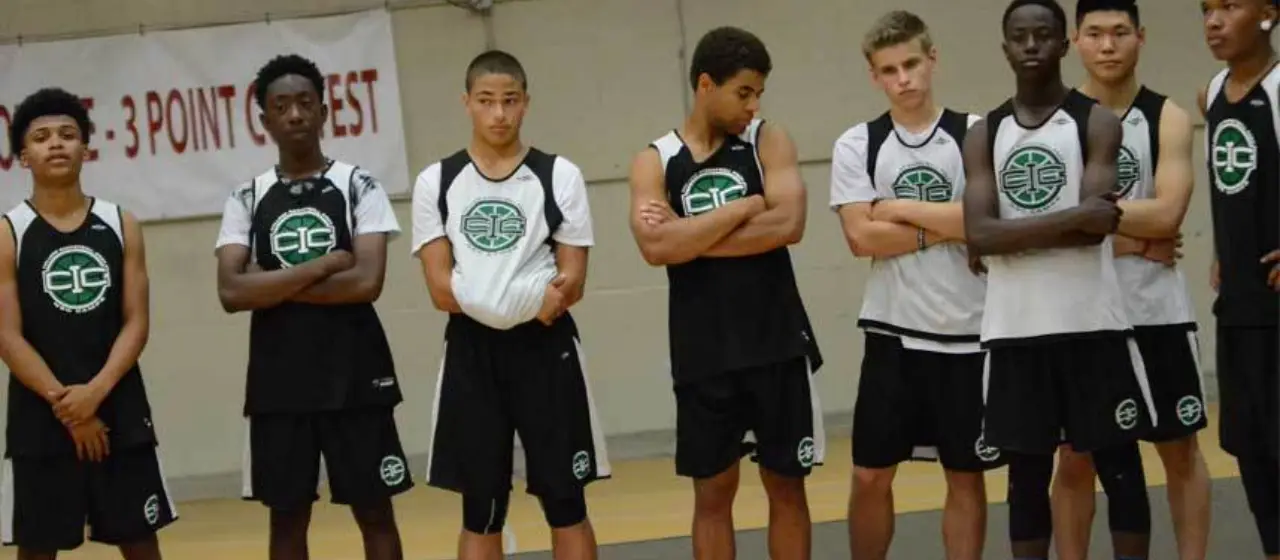 Players wait on sideline for daily camp drafts at college prep camp.
