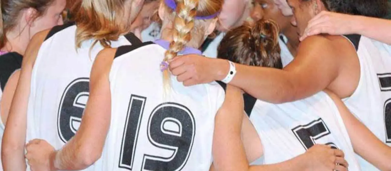 Girls basketball team huddle at camp