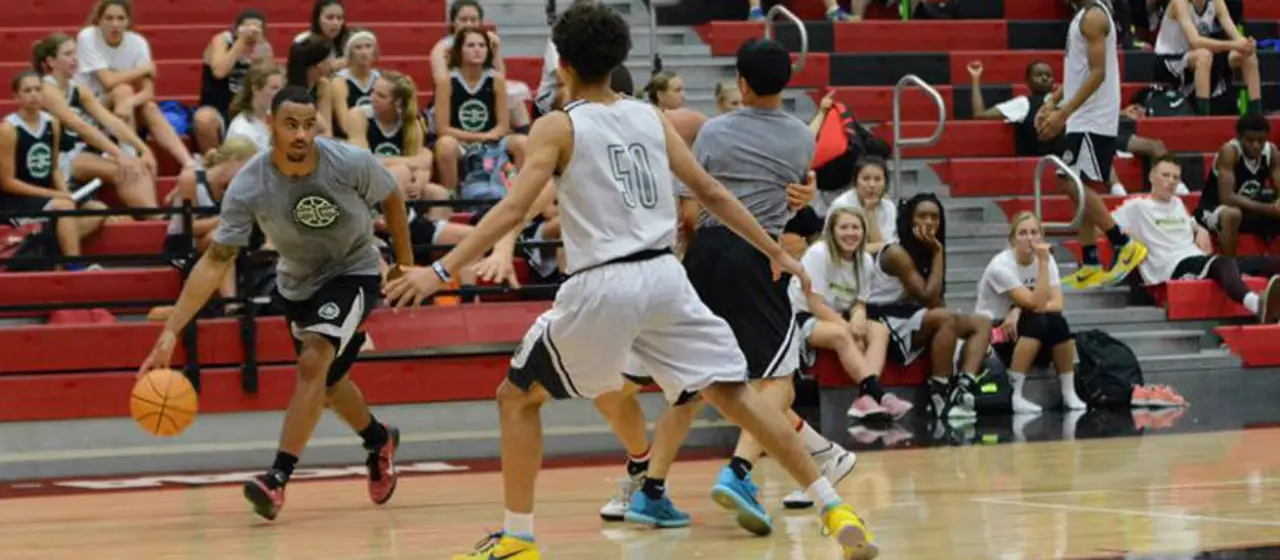 Davonte Lacy drives to basket at College basketball Prep Camp coaches versus camper game