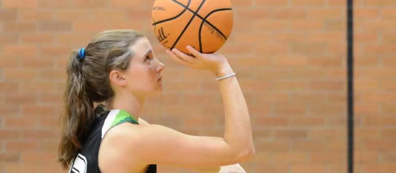 Female athlete focuses on on accurate shooting mechanics at NBC Basketball Camps