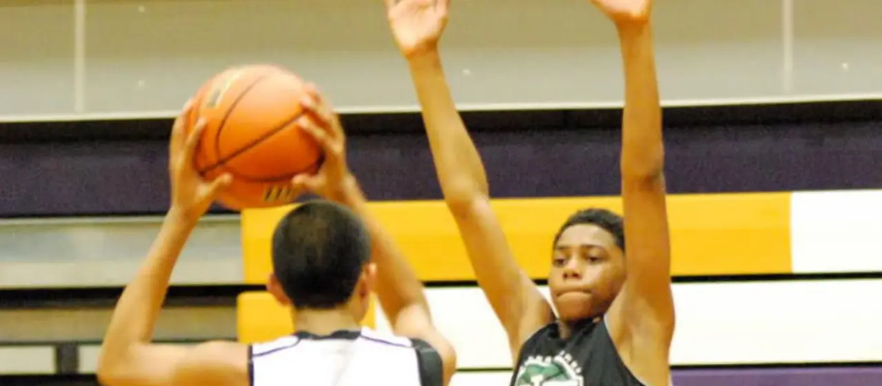 Basketball players inbound the pass during games at camp