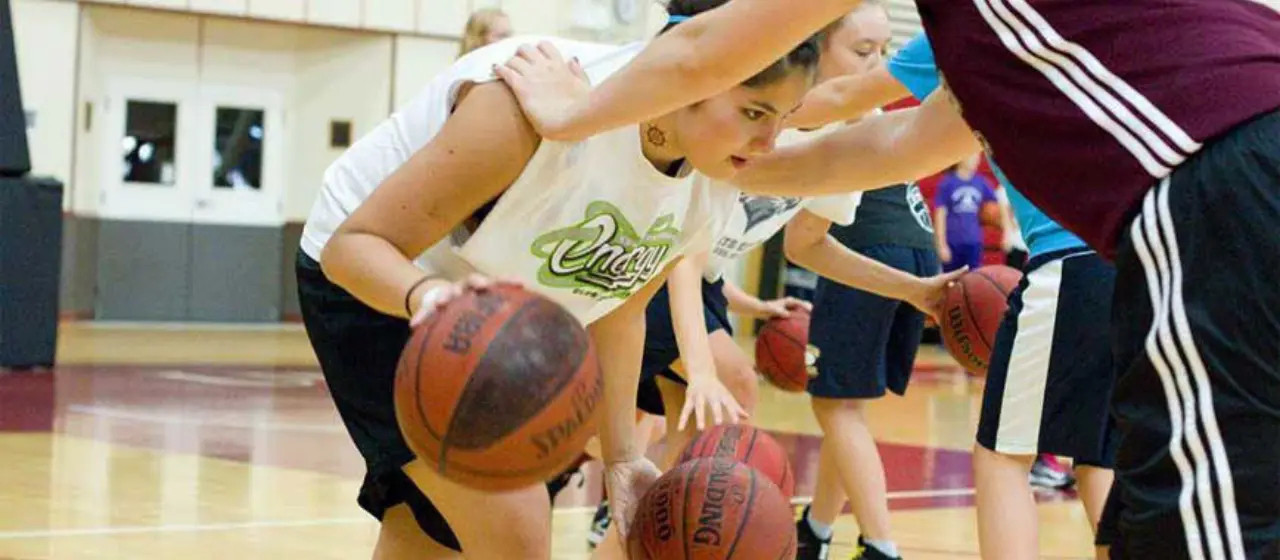 Players provide resistance training during NBC Basketball Camp ball handling drills