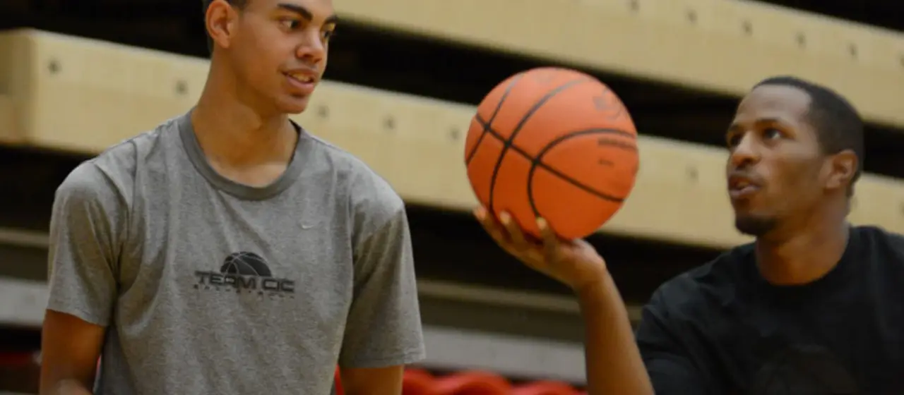 Coach makes recommendation to athlete at camp.