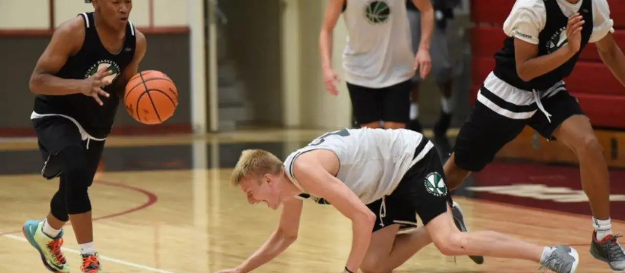 Player slaps floor in frustration after a turn-over at basketball camp.