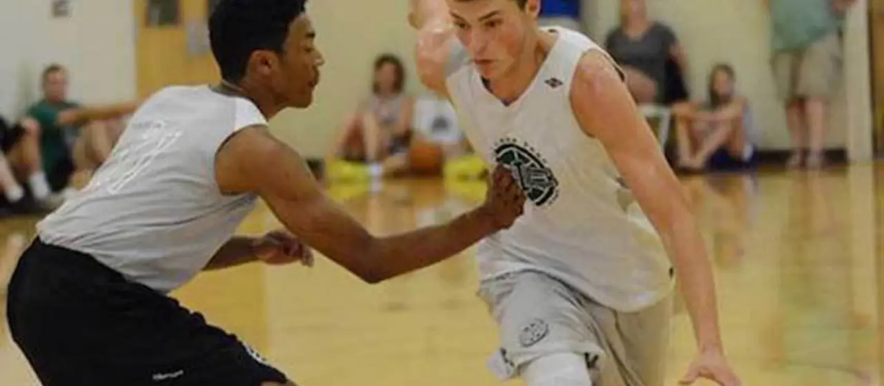 Player drives to the basket at USA elite college basketball prep camp hosted by NBC Camps.