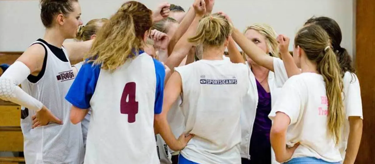 Girls at high school basketball camp come together in team cheer