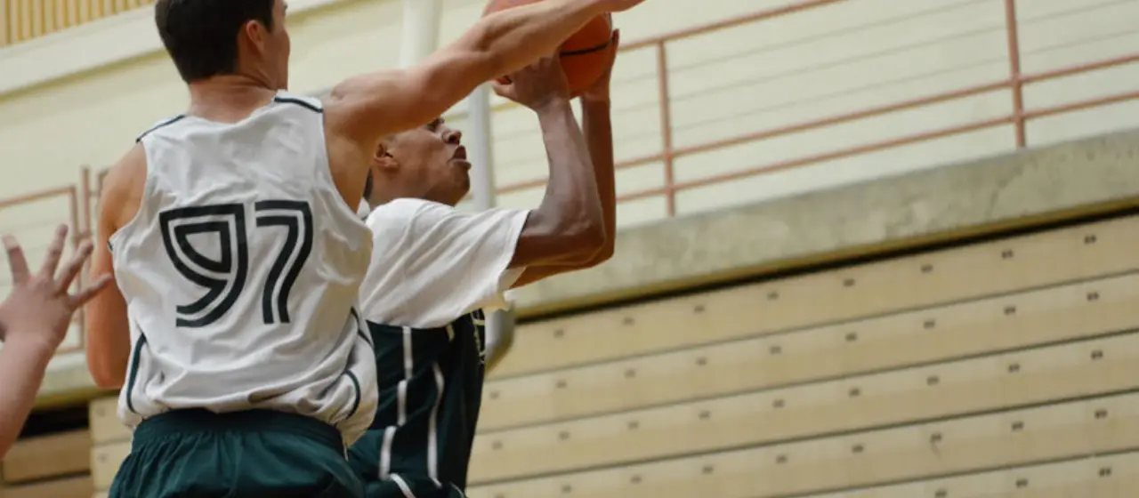 Basketball player tries to block shot at NBC Basketball Camps