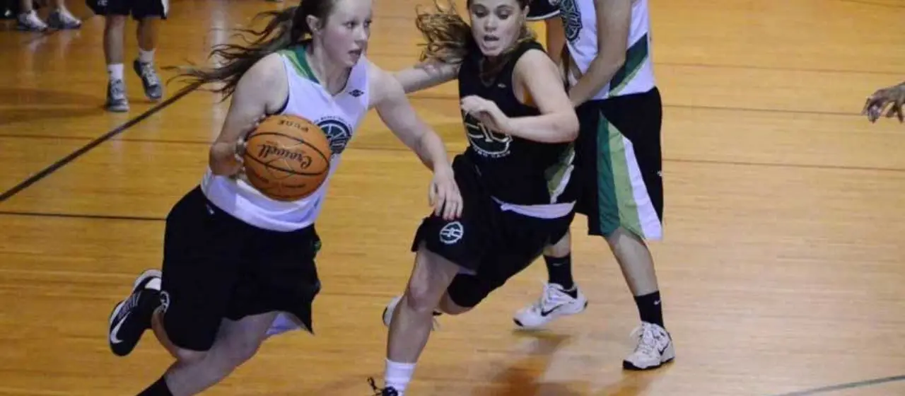 Player attacks basketball as a defender comes late off screen at NBC Girls Basketball Camp