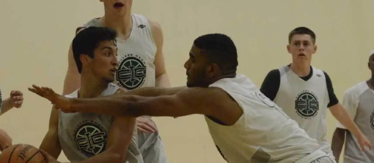 Point guard navigates pressure defense at college basketball prep camp.