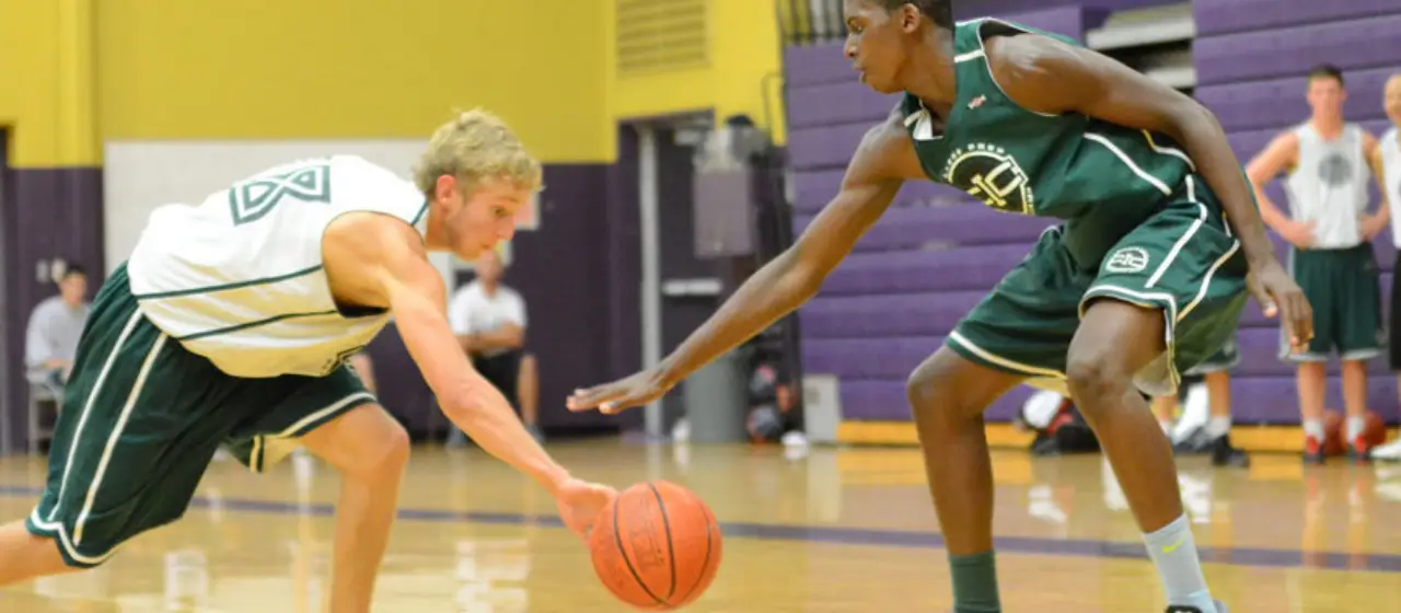 Basketball player loses possession of the ball during college basketball prep camp