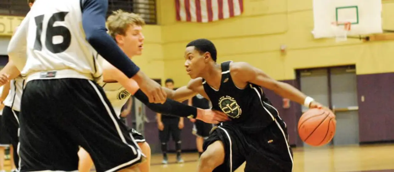 Basketball camper practicing point guard skills at College basketball prep camp NBC Basketball