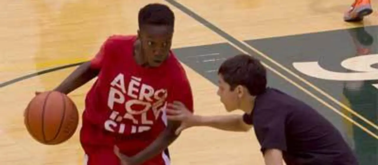 Athlete drive to basket at UAA gym in Anchorage with NBC Basketball Camps