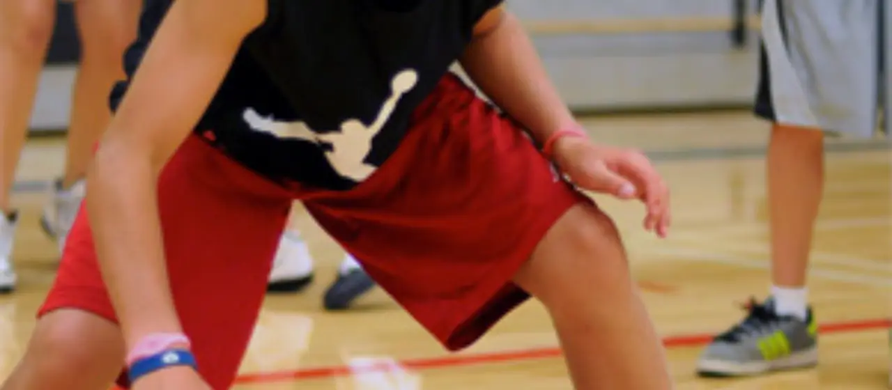 Athlete works on dribbling drills at camp