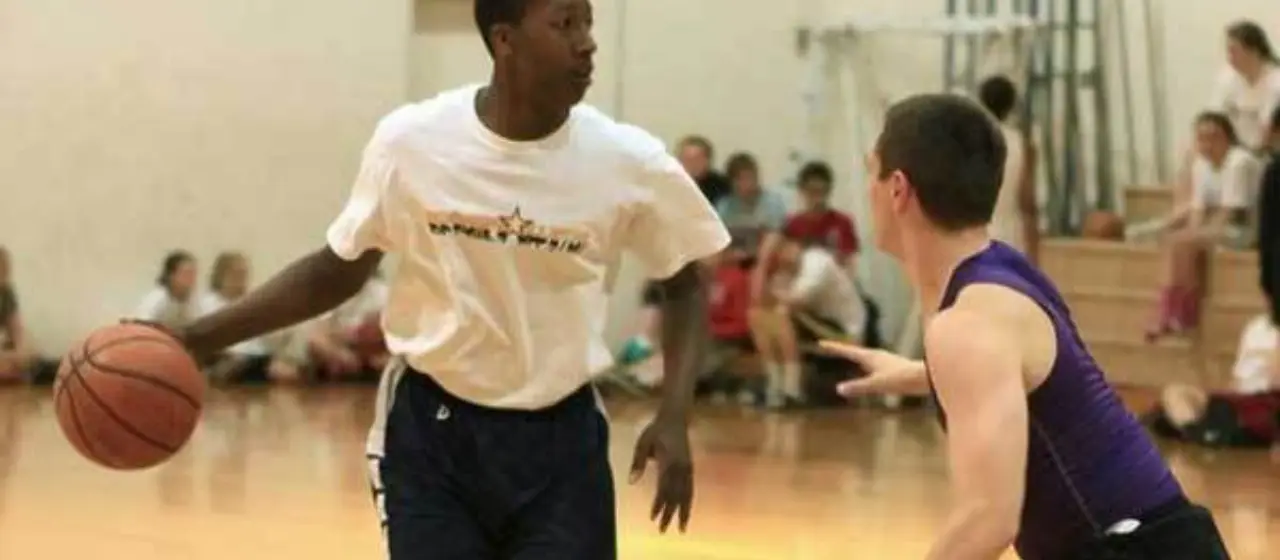 Athlete looks up the floor at camp all-star game at NBC Basketball Camps