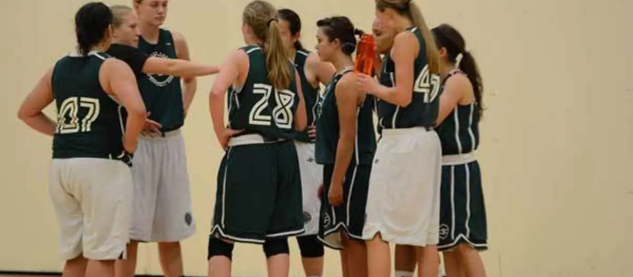 Girls basketball huddle at camp