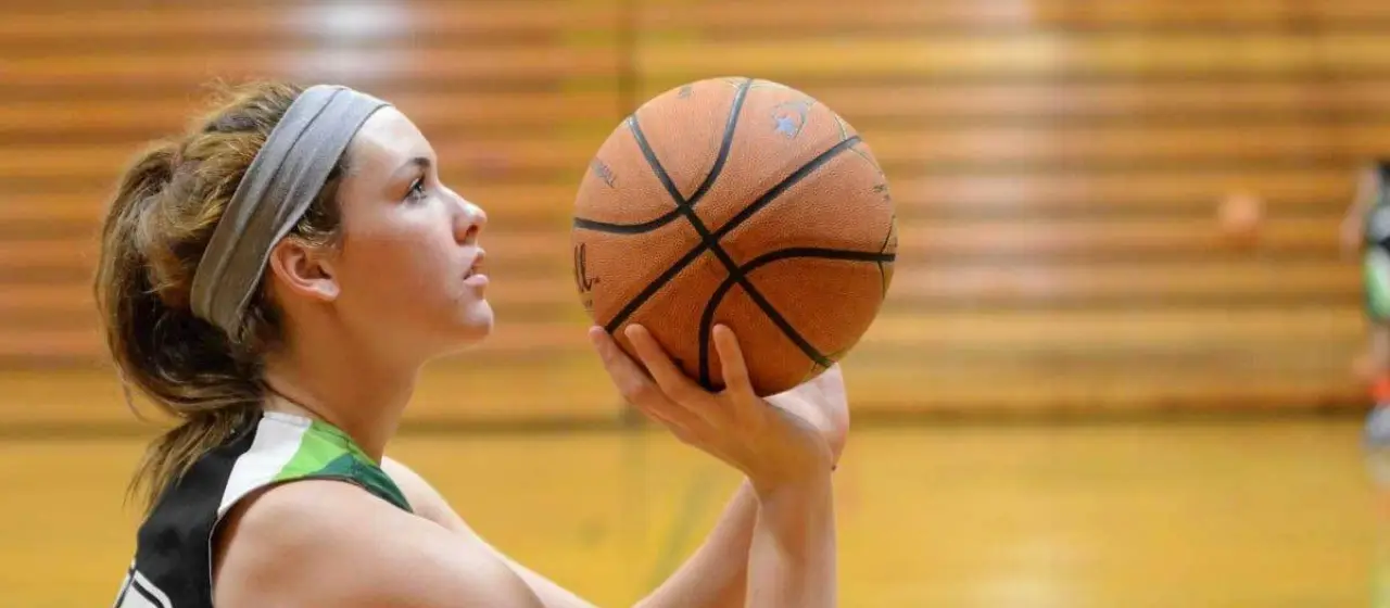 Girl basketball player practices shooting form at NBC Basketball Camps