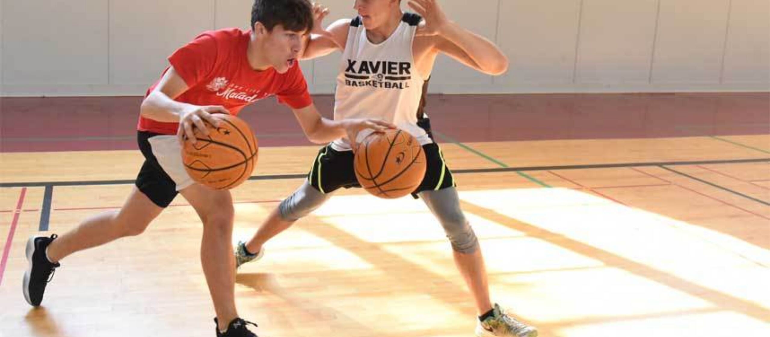 Athletes do two ball drills at NBC basketball camp.