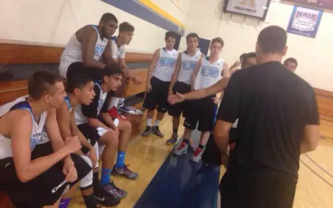 Basketball travel team time out as coach preps team for win.