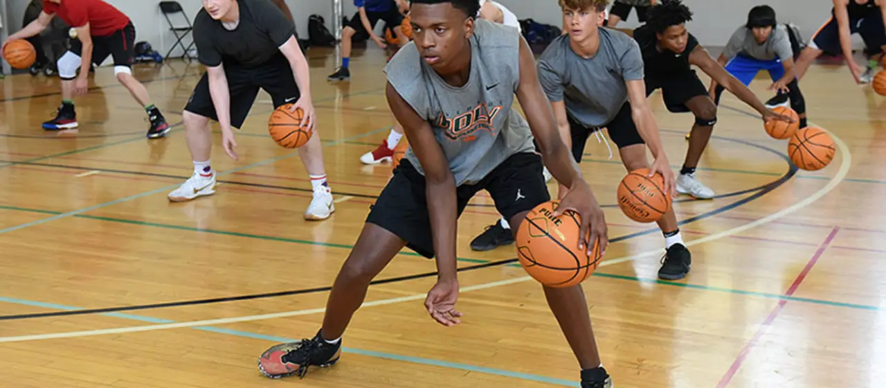 Athletes work on ball handling skills at intensive basketball camp hosted by NBC Basketball.