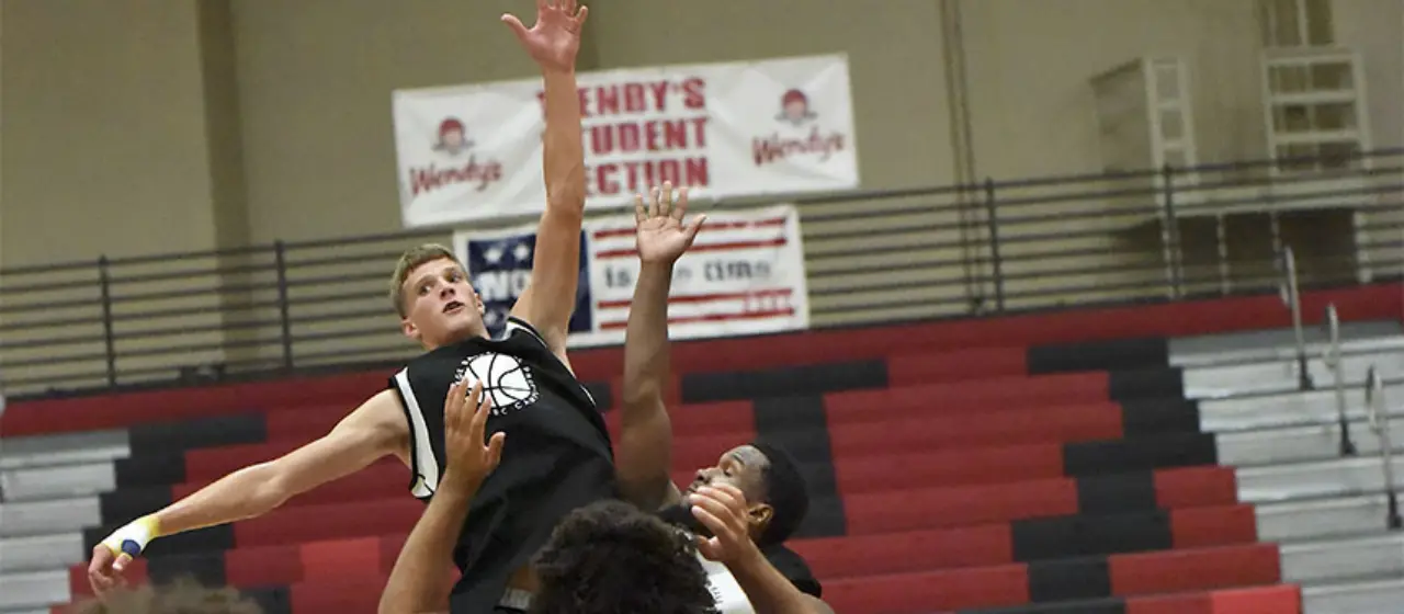 Athletes compete in a tip off at NBC Basketball Tournament Games