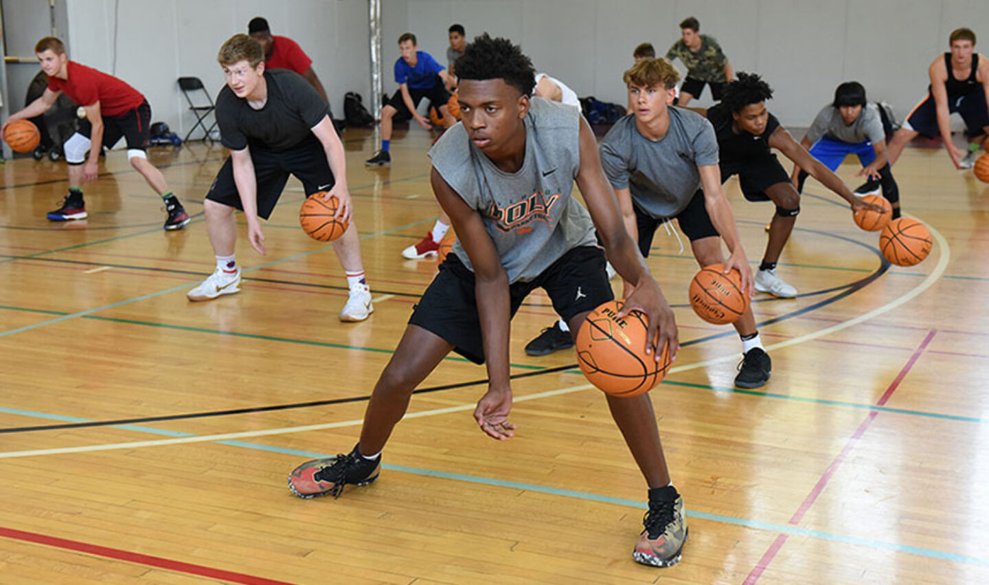 Athletes work on ball handling skills at intensive basketball camp hosted by NBC Basketball.
