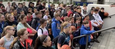 NBC Alaska Basketball Camp campers line up for morning roll call before heading to ball handling