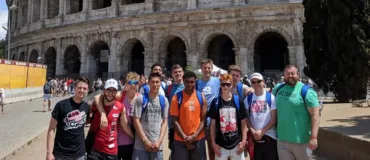 Boys Travel Team to Italy - In front of Colosseum in Rome