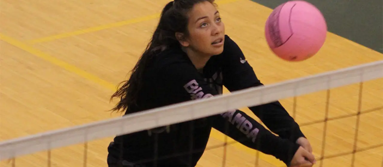 Younger volleyball camper tracks ball during training camp