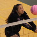 Younger volleyball camper tracks ball during training camp