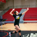 Camper practices overhand serve at NBC Volleyball Clinics